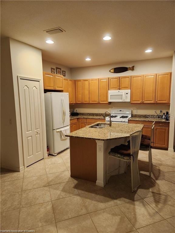 1375 Backspin Dr, Englewood, FL 34223 - kitchen featuring recessed lighting, a center island with sink, a sink, and white appliances