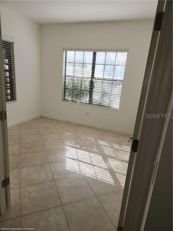 1375 Backspin Dr, Englewood, FL 34223 - unfurnished room with baseboards and light tile patterned floors