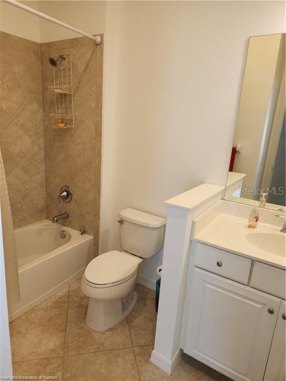 1375 Backspin Dr, Englewood, FL 34223 - bathroom with tile patterned floors, toilet, vanity, baseboards, and  shower combination
