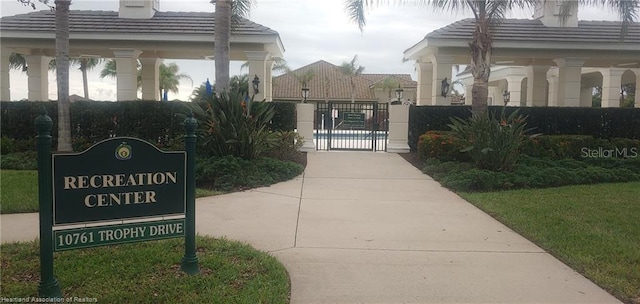 1375 Backspin Dr, Englewood, FL 34223 - view of property's community with a gate and fence
