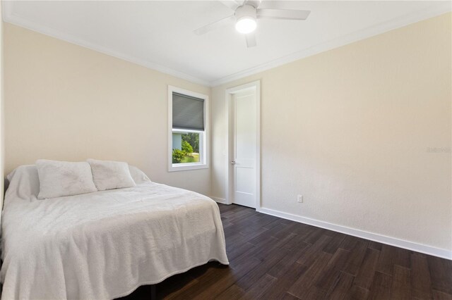 bedroom featuring crown molding, baseboards, a ceiling fan, and dark wood-type flooring