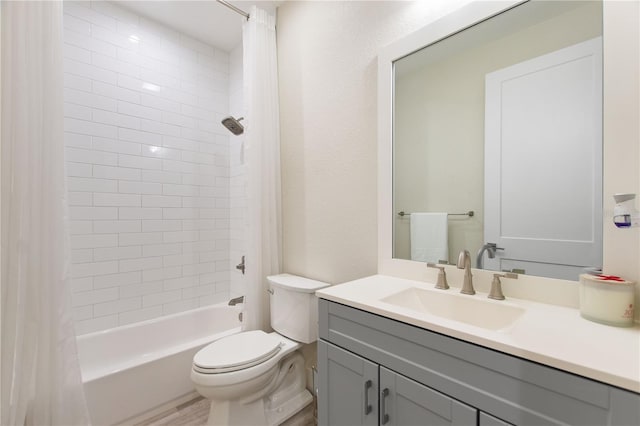 bathroom featuring toilet, shower / bath combo, and vanity