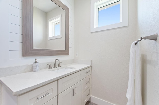 bathroom featuring vanity and baseboards