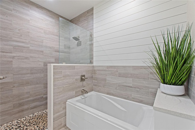 full bath featuring a garden tub and walk in shower