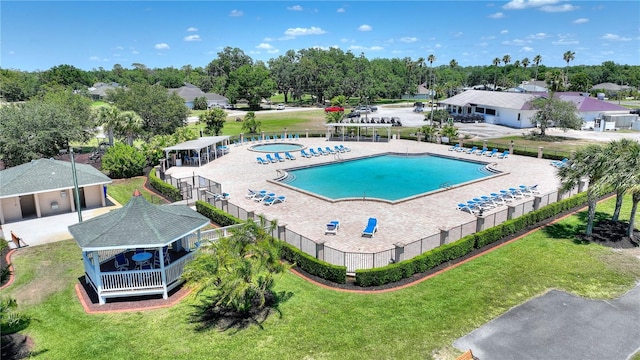 pool featuring a yard, a gazebo, and fence