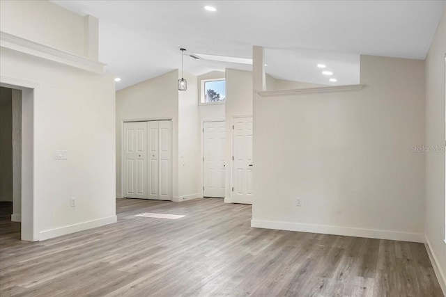 spare room with baseboards, recessed lighting, and wood finished floors
