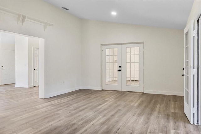 unfurnished room with french doors, baseboards, wood finished floors, and visible vents