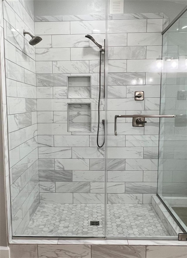 full bath featuring visible vents and a stall shower