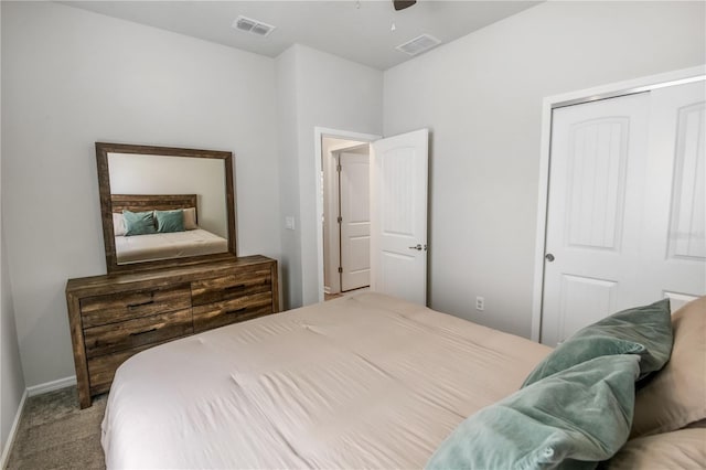 carpeted bedroom featuring a ceiling fan, baseboards, visible vents, and a closet