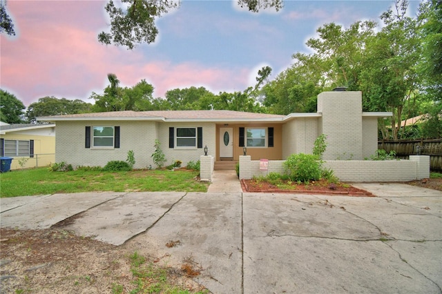 1919 19th St NW, Winter Haven, FL 33881 - view of front of property featuring a chimney and brick siding