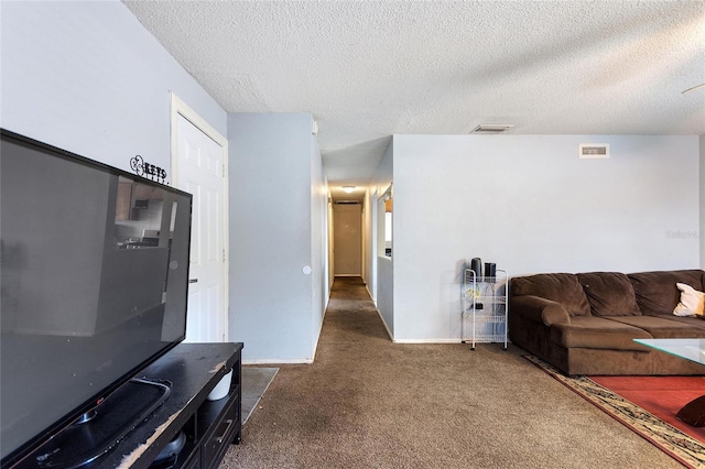 carpeted living room with a textured ceiling, visible vents, and baseboards