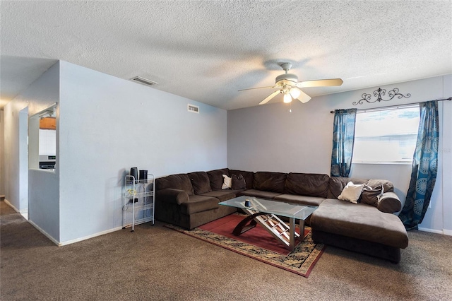 carpeted living area featuring baseboards, a ceiling fan, a textured ceiling, and visible vents