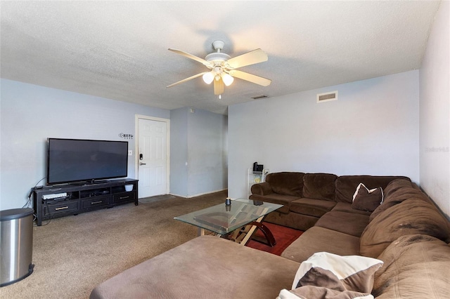 carpeted living room featuring a textured ceiling, ceiling fan, and visible vents