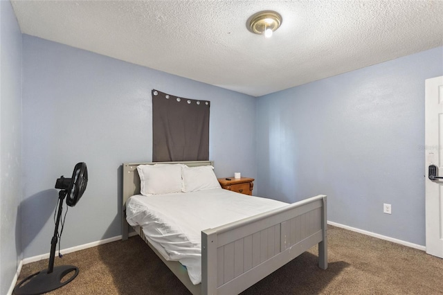 bedroom with baseboards, a textured ceiling, and carpet