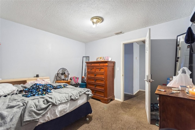 carpeted bedroom with visible vents and a textured ceiling