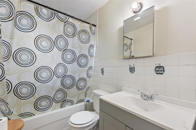 bathroom featuring vanity, toilet, tile walls, a textured ceiling, and shower / bath combo