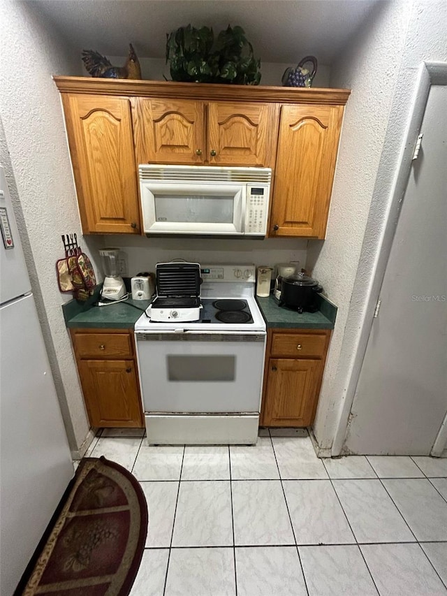 kitchen with brown cabinets and white appliances