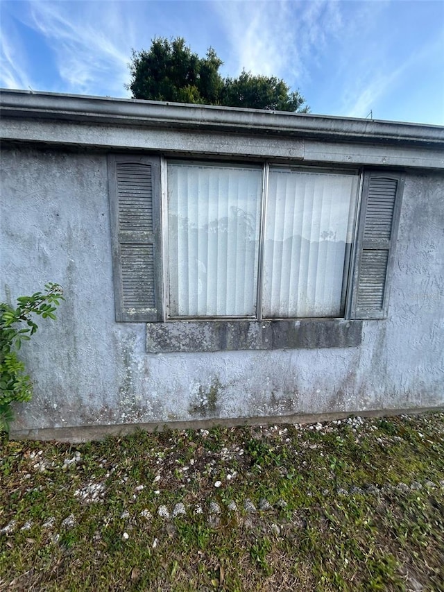 view of side of home with stucco siding