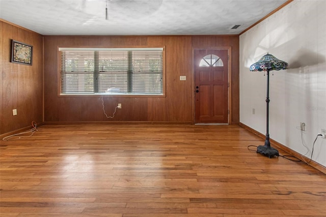 1371 Sheridan St SW, Winter Haven, FL 33880 - foyer with light wood-type flooring, wooden walls, and visible vents