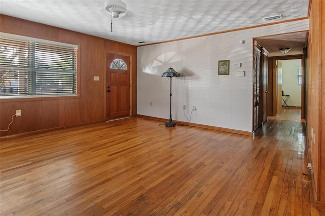 1371 Sheridan St SW, Winter Haven, FL 33880 - foyer with baseboards, ornamental molding, light wood-type flooring, and visible vents