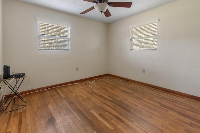 1371 Sheridan St SW, Winter Haven, FL 33880 - unfurnished room with a healthy amount of sunlight, baseboards, ceiling fan, and hardwood / wood-style flooring