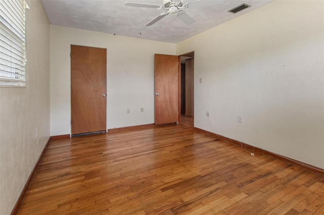 1371 Sheridan St SW, Winter Haven, FL 33880 - unfurnished bedroom with visible vents, a ceiling fan, baseboards, and wood finished floors