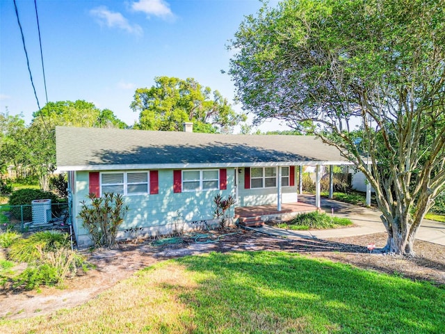 1371 Sheridan St SW, Winter Haven, FL 33880 - ranch-style home with fence, a porch, a chimney, a carport, and driveway