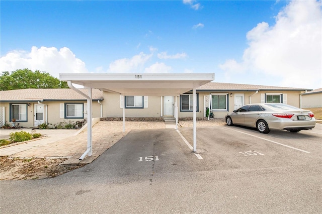 151 Winter Ridge Dr Unit 151, Winter Haven, FL 33881 - view of front of property featuring covered and uncovered parking and stucco siding