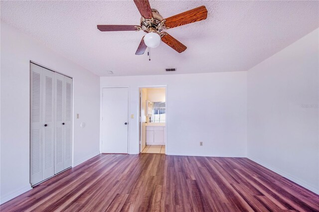 151 Winter Ridge Dr Unit 151, Winter Haven, FL 33881 - unfurnished bedroom with a ceiling fan, a textured ceiling, visible vents, wood finished floors, and a closet