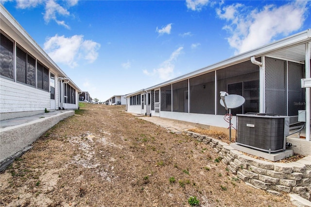 151 Winter Ridge Dr Unit 151, Winter Haven, FL 33881 - view of yard with a sunroom and central air condition unit