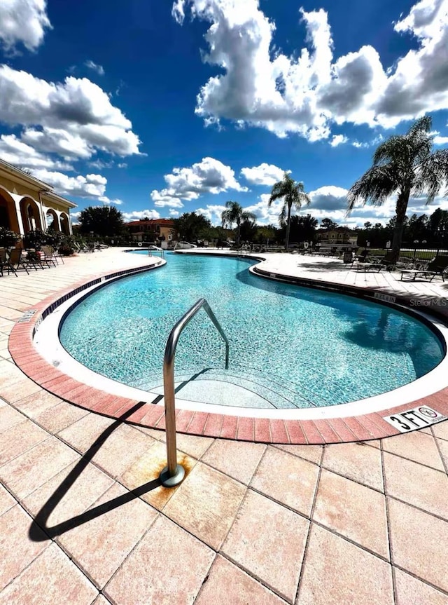 community pool with a patio area
