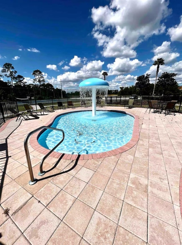 pool featuring a patio and fence