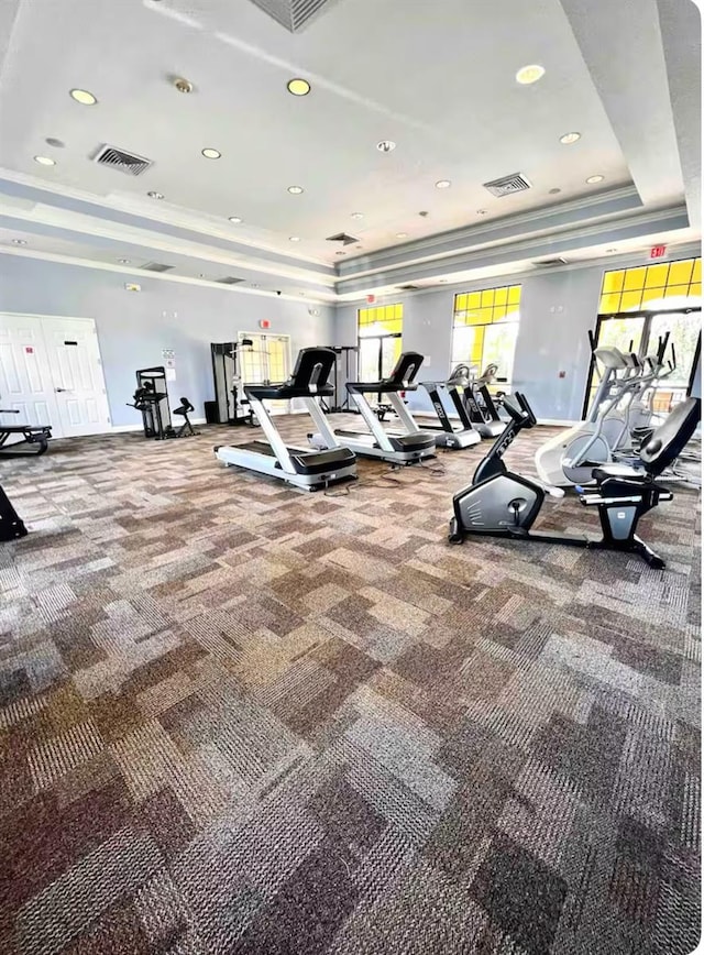 exercise room featuring carpet flooring, recessed lighting, visible vents, and a raised ceiling