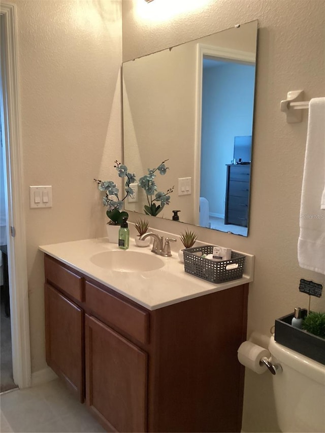 bathroom featuring toilet and vanity