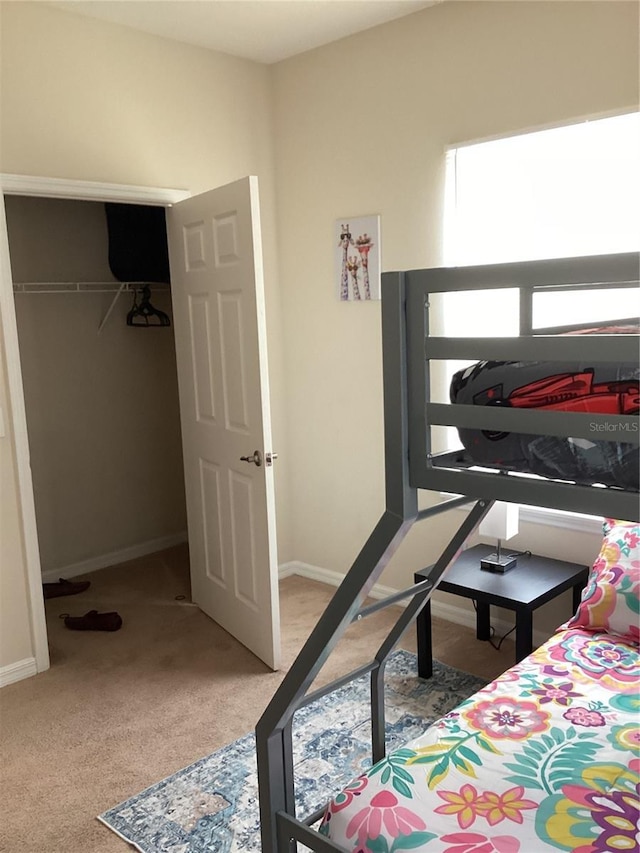 bedroom with baseboards and carpet flooring