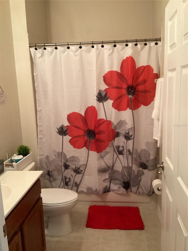 full bath with vanity, tile patterned floors, toilet, and shower / bath combo with shower curtain