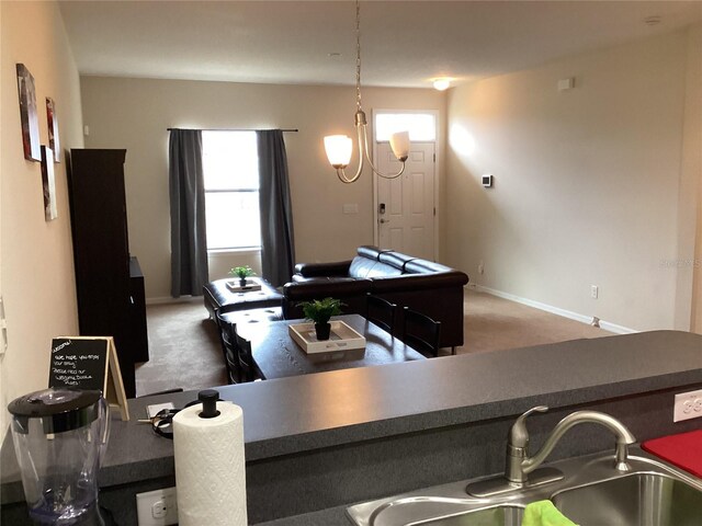 interior space featuring a sink, carpet floors, and baseboards