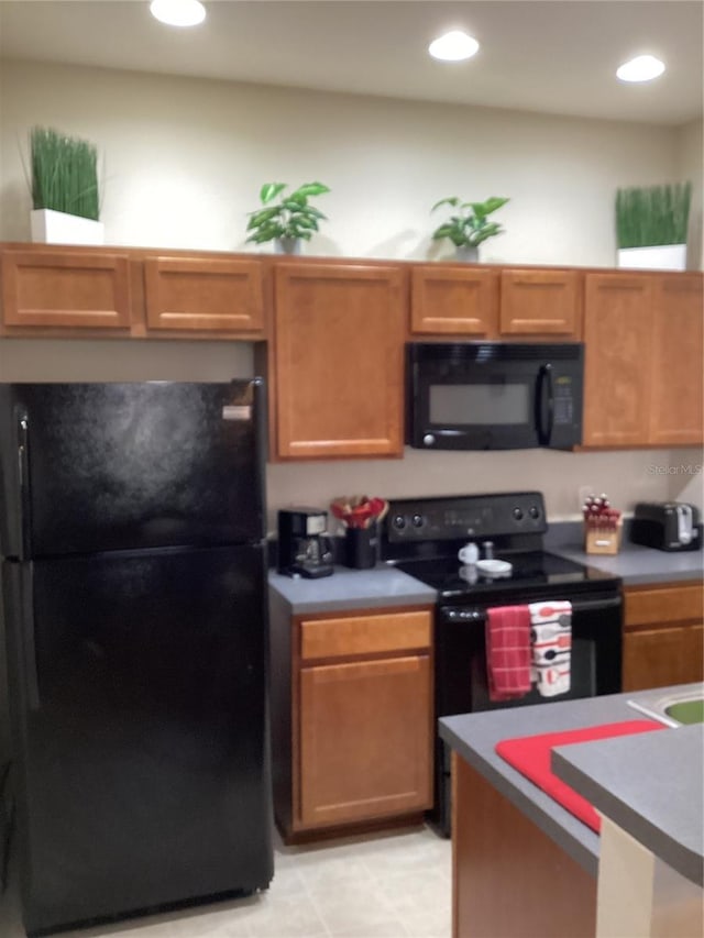 kitchen featuring black appliances and recessed lighting