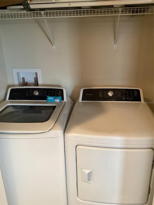 washroom featuring washer and dryer and laundry area