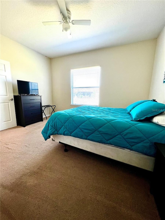 bedroom featuring ceiling fan and carpet flooring