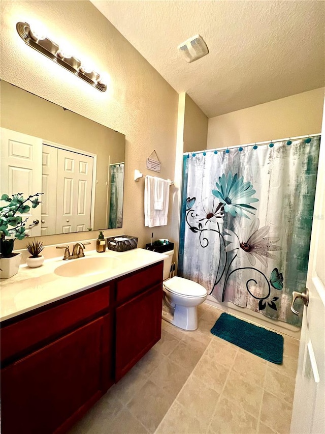 bathroom featuring visible vents, vanity, toilet, a textured ceiling, and a shower with curtain