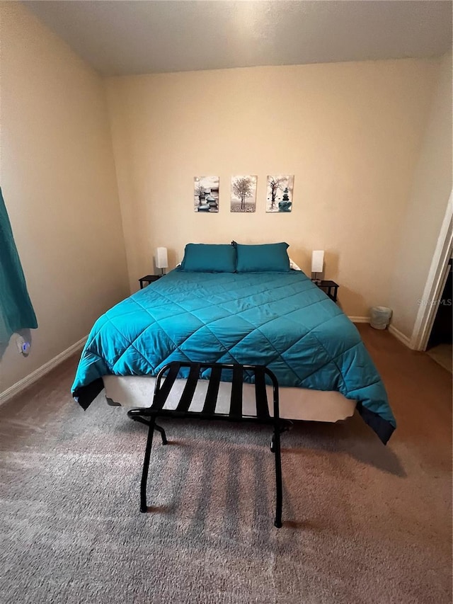 carpeted bedroom featuring baseboards