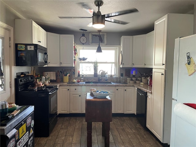 124 Palm Pl, Haines City, FL 33844 - kitchen with black appliances, a ceiling fan, white cabinetry, and a textured ceiling