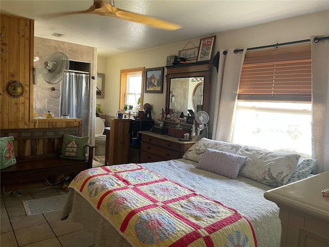 124 Palm Pl, Haines City, FL 33844 - tiled bedroom with a ceiling fan