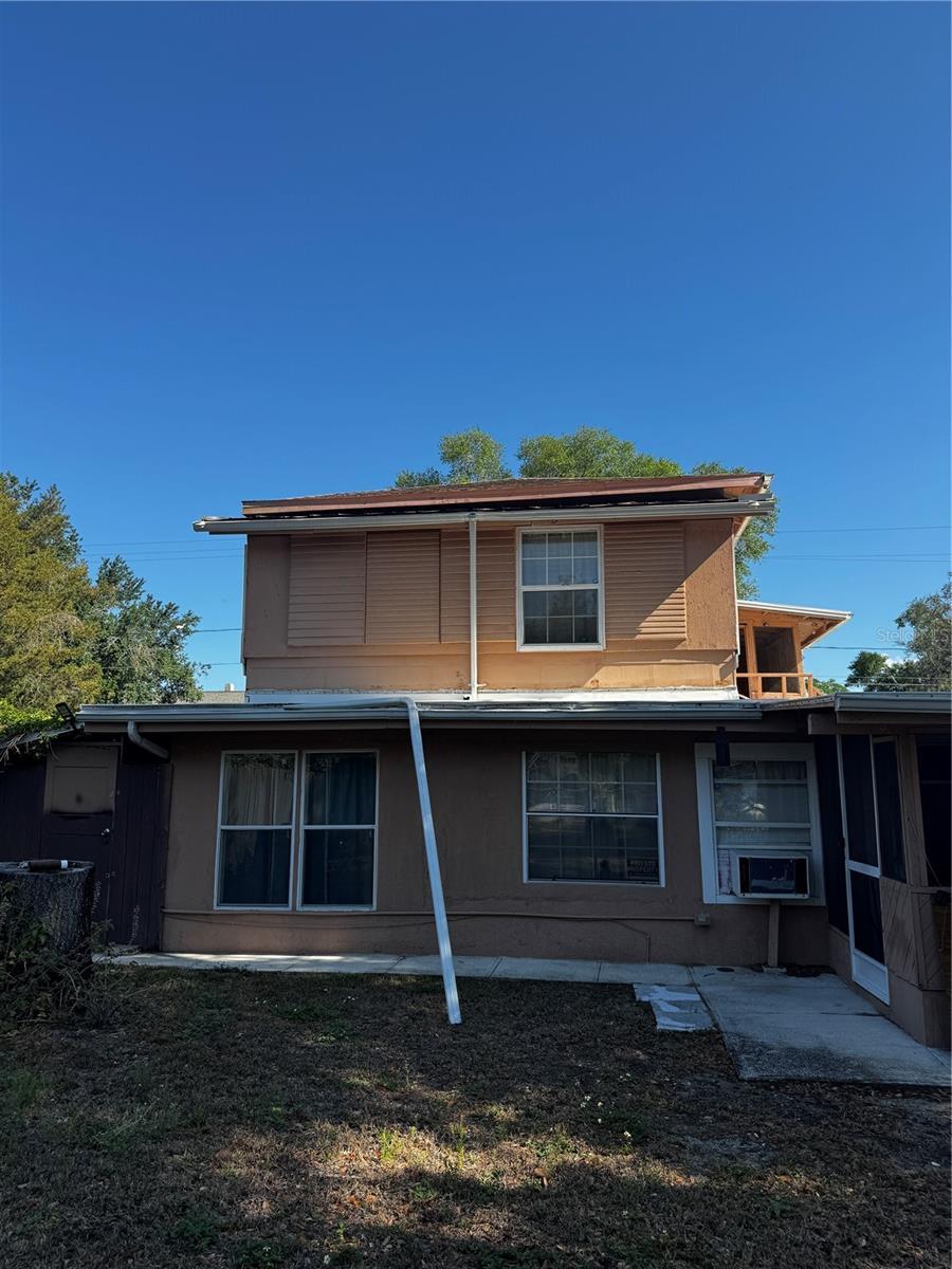 229 NE Ave B, Winter Haven, FL 33881 - rear view of property featuring a sunroom