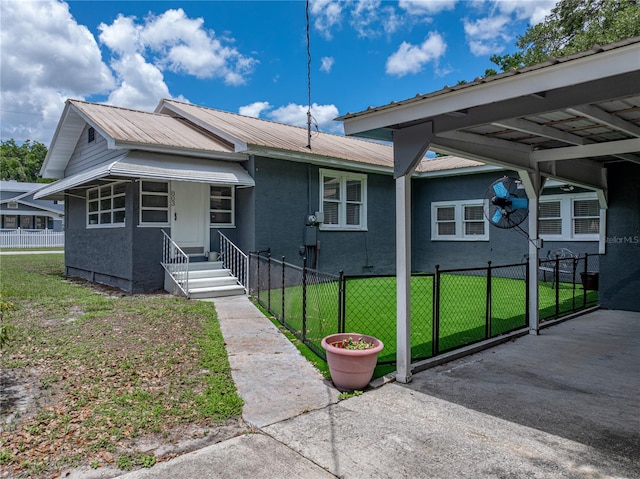 803 7th St NE, Fort Meade, FL 33841 - view of front of property featuring metal roof, a carport, stucco siding, and entry steps