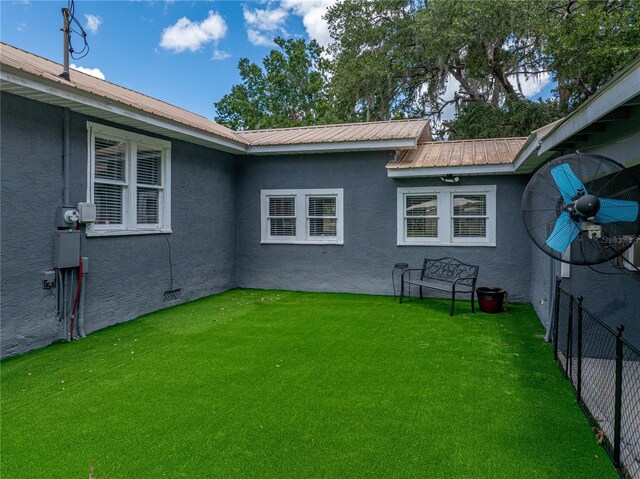 803 7th St NE, Fort Meade, FL 33841 - rear view of house with stucco siding and metal roof