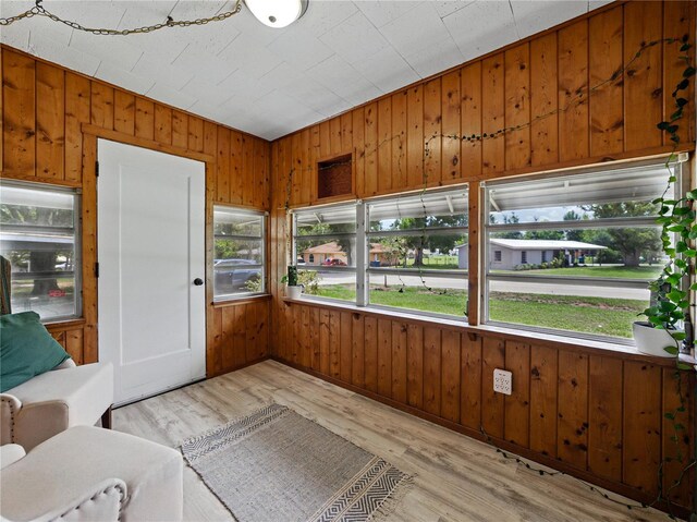 803 7th St NE, Fort Meade, FL 33841 - unfurnished sunroom featuring healthy amount of natural light, wood walls, and wood finished floors