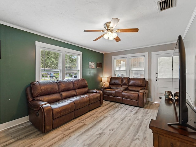803 7th St NE, Fort Meade, FL 33841 - living room with crown molding, wood finished floors, ceiling fan, and baseboards