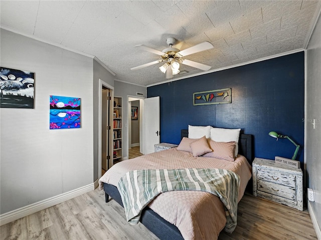 803 7th St NE, Fort Meade, FL 33841 - bedroom featuring wood finished floors, crown molding, baseboards, and ceiling fan